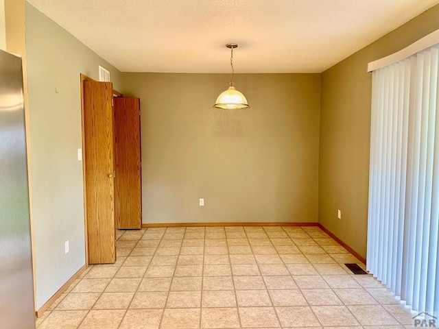 empty room with visible vents and baseboards