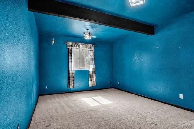368 S Camino De Los Ranchos, Pueblo West, CO 81007 - carpeted empty room with beam ceiling and a textured wall