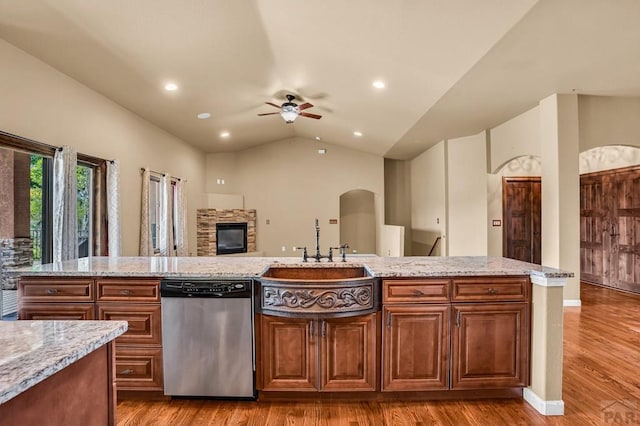 368 S Camino De Los Ranchos, Pueblo West, CO 81007 - kitchen with dishwasher, a ceiling fan, light wood-style floors, vaulted ceiling, and light stone counters