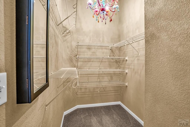 368 S Camino De Los Ranchos, Pueblo West, CO 81007 - walk in closet featuring carpet and a chandelier