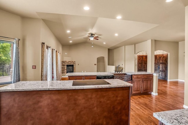 368 S Camino De Los Ranchos, Pueblo West, CO 81007 - kitchen with a large island, black appliances, ceiling fan, arched walkways, and light wood-type flooring