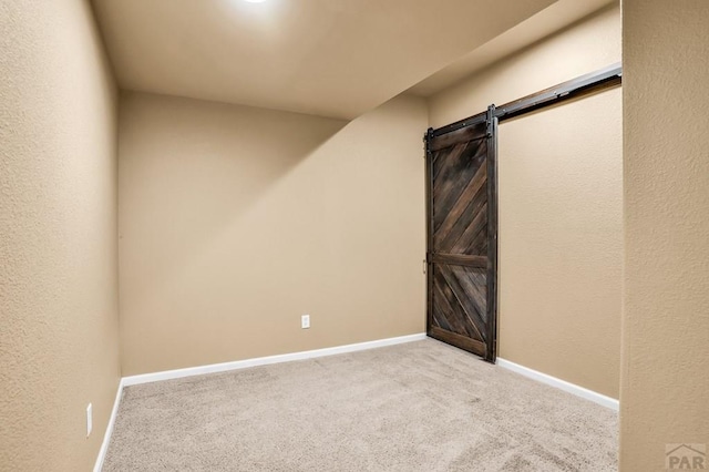 368 S Camino De Los Ranchos, Pueblo West, CO 81007 - carpeted spare room with baseboards and a barn door