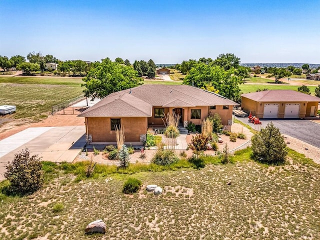 368 S Camino De Los Ranchos, Pueblo West, CO 81007 - view of front facade featuring covered porch, gravel driveway, and a garage