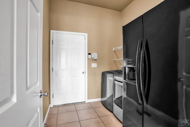368 S Camino De Los Ranchos, Pueblo West, CO 81007 - laundry area featuring washer and clothes dryer and light tile patterned floors