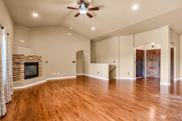 368 S Camino De Los Ranchos, Pueblo West, CO 81007 - unfurnished living room with arched walkways, ceiling fan, a fireplace, light wood-style floors, and recessed lighting