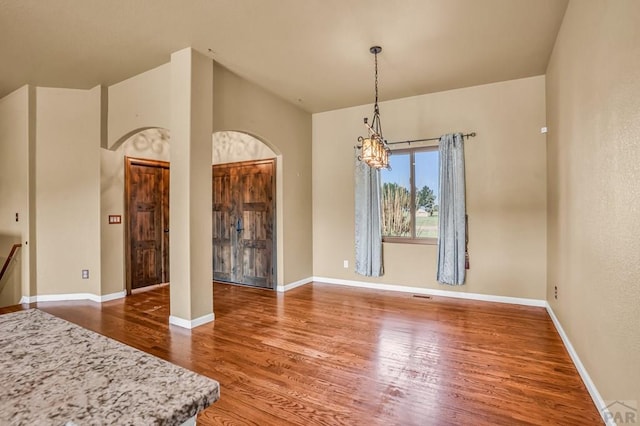 368 S Camino De Los Ranchos, Pueblo West, CO 81007 - dining room with a chandelier, wood finished floors, and arched walkways