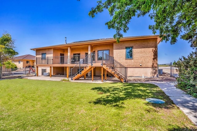 368 S Camino De Los Ranchos, Pueblo West, CO 81007 - back of house with stairs, a patio, stucco siding, and a deck