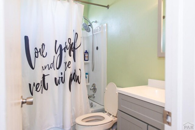 full bath featuring toilet, shower / bath combo with shower curtain, and vanity