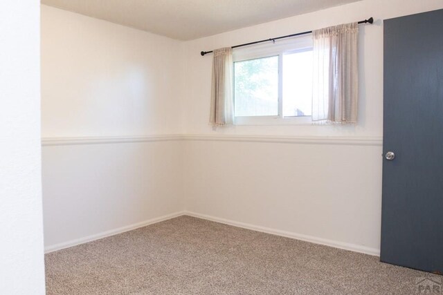 spare room with carpet floors and baseboards