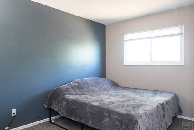 carpeted bedroom with baseboards