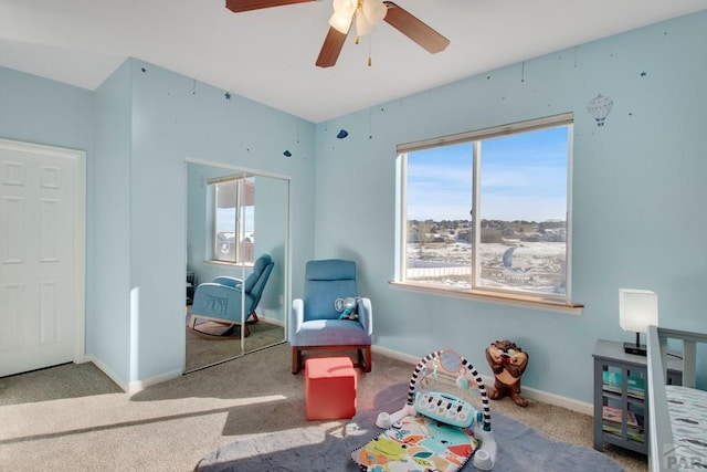 playroom with a ceiling fan, carpet, and baseboards