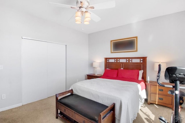 bedroom featuring light carpet, a closet, and a ceiling fan