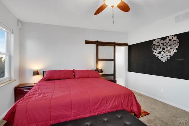 bedroom with a ceiling fan, carpet flooring, visible vents, and baseboards