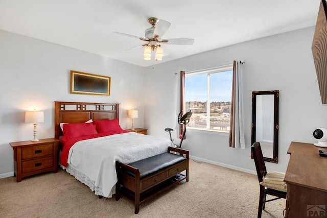 bedroom with light carpet, ceiling fan, and baseboards