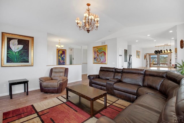 living room with visible vents, an inviting chandelier, light wood-style floors, vaulted ceiling, and baseboards