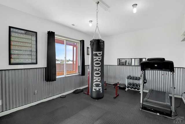 exercise area featuring a wainscoted wall and visible vents