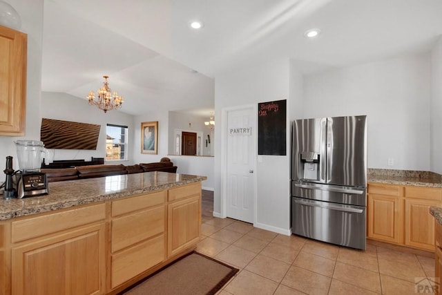 kitchen with light tile patterned floors, light brown cabinets, stainless steel refrigerator with ice dispenser, and open floor plan