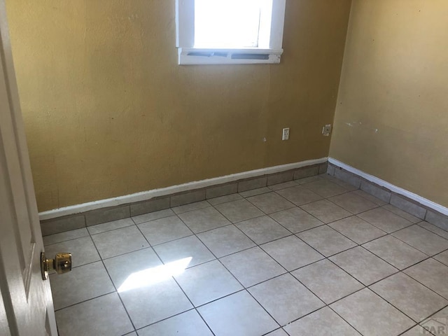 1905 E Evans Ave, Pueblo, CO 81004 - unfurnished room featuring light tile patterned flooring and baseboards
