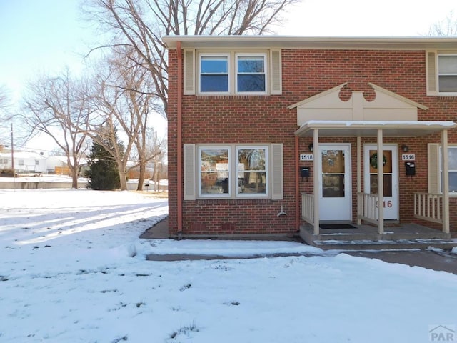 townhome / multi-family property with brick siding