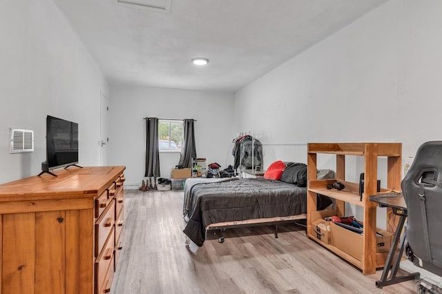 bedroom with visible vents and light wood-style floors