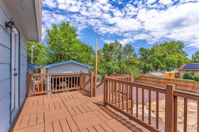 wooden deck with a fenced backyard