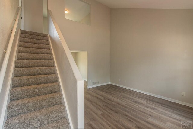 stairs featuring baseboards and wood finished floors