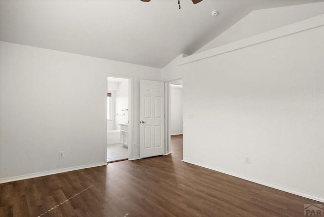 empty room with vaulted ceiling, a ceiling fan, dark wood-style flooring, and baseboards