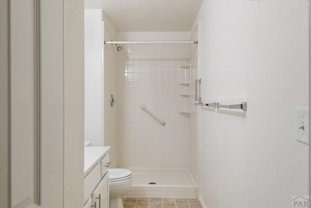 full bath featuring a stall shower, toilet, and vanity