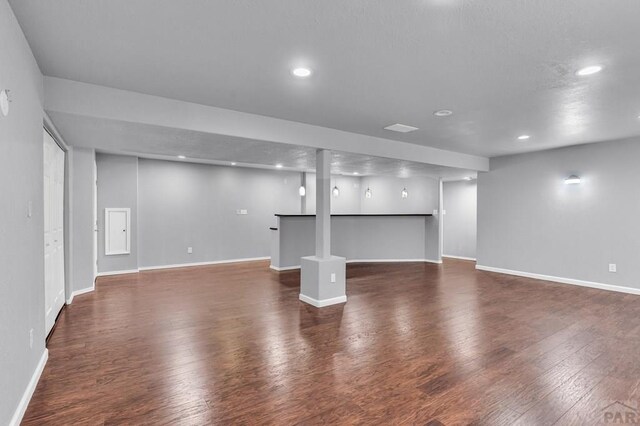 interior space with recessed lighting, dark wood-style flooring, and baseboards