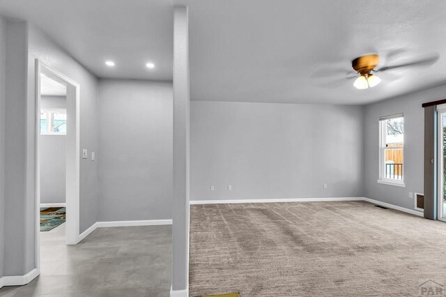 empty room with carpet floors, recessed lighting, visible vents, a ceiling fan, and baseboards