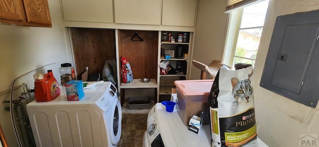 clothes washing area with cabinet space, electric panel, and separate washer and dryer