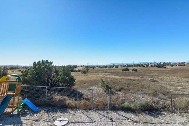 view of yard with playground community and fence