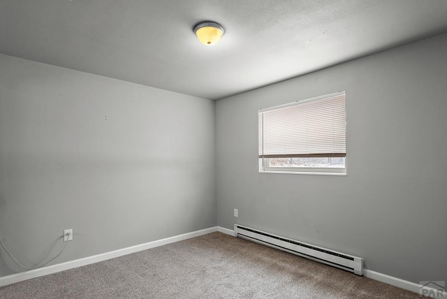 carpeted empty room featuring baseboards and a baseboard heating unit