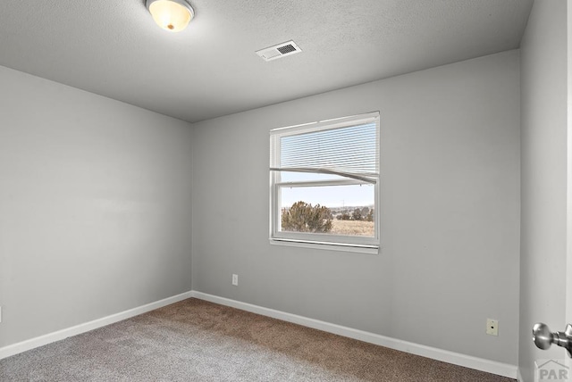 empty room featuring baseboards, a textured ceiling, visible vents, and carpet flooring