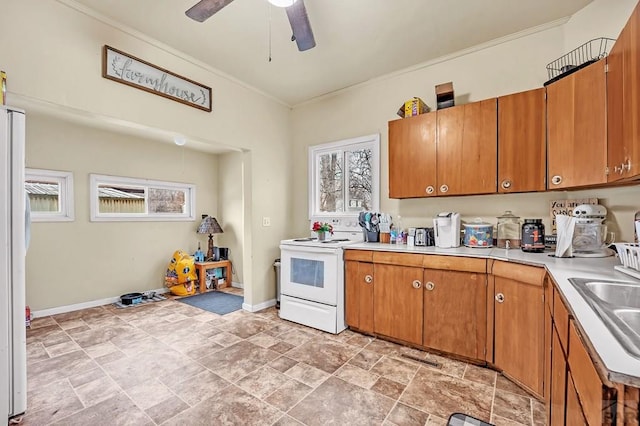 kitchen with brown cabinets, white appliances, light countertops, and crown molding