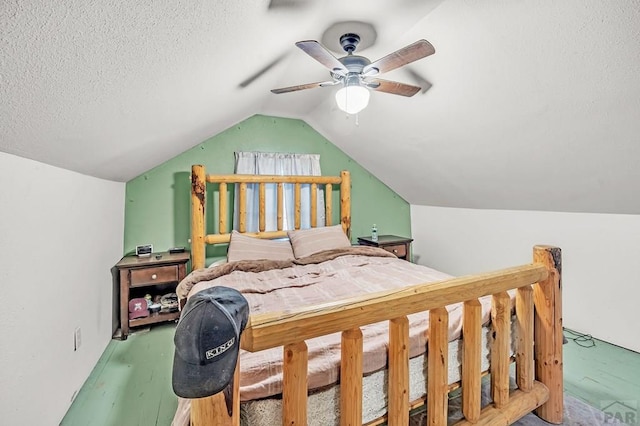 bedroom featuring vaulted ceiling, a textured ceiling, and ceiling fan