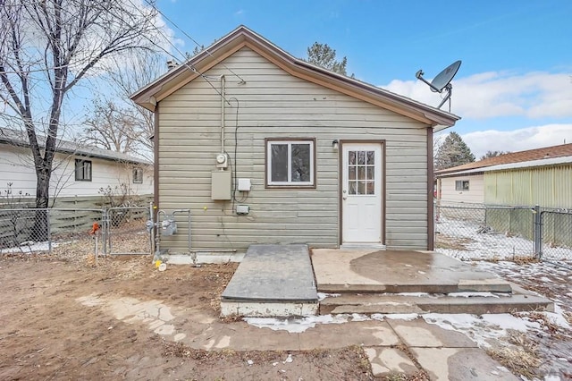 snow covered property with fence and a gate