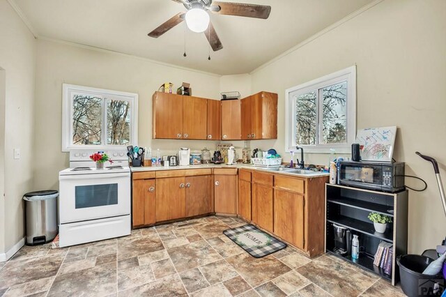 kitchen with light countertops, brown cabinetry, a sink, and white electric range oven