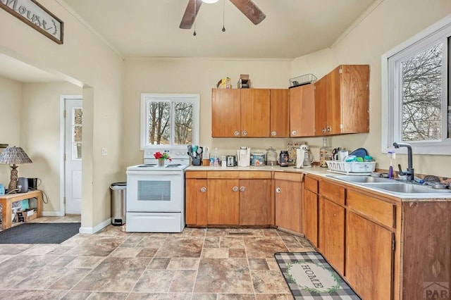 kitchen featuring a sink, brown cabinets, light countertops, and electric stove