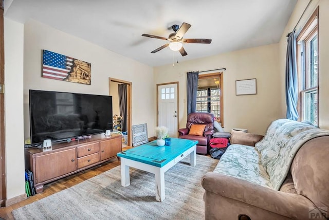 living room with a ceiling fan and wood finished floors