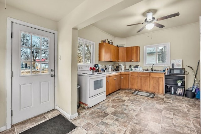 kitchen featuring white electric range oven, brown cabinets, light countertops, black microwave, and a sink