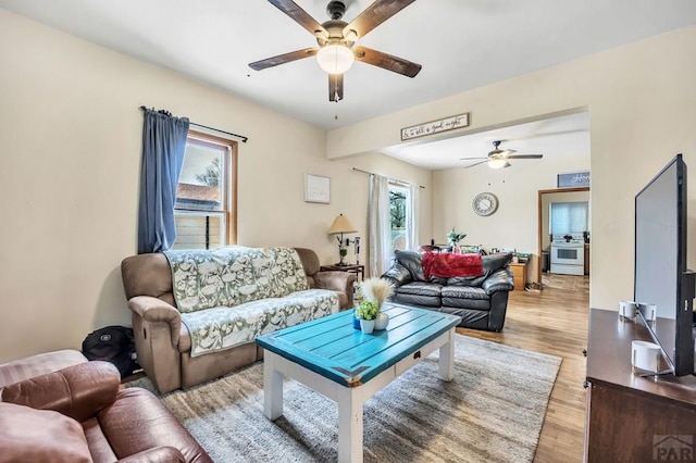 living room with light wood finished floors and ceiling fan