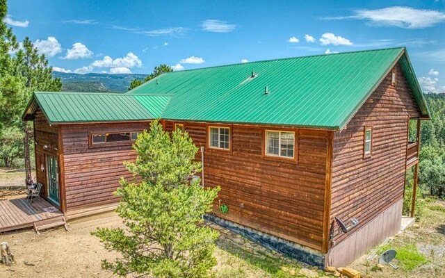 back of property featuring metal roof