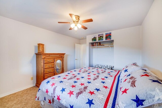 bedroom featuring light carpet, ceiling fan, and baseboards