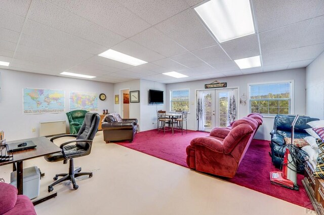 carpeted office featuring french doors and a drop ceiling