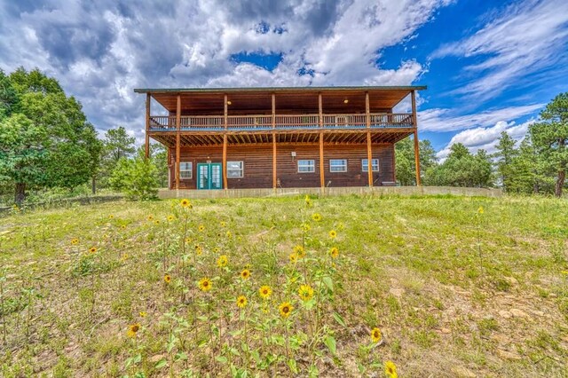 back of property featuring log veneer siding