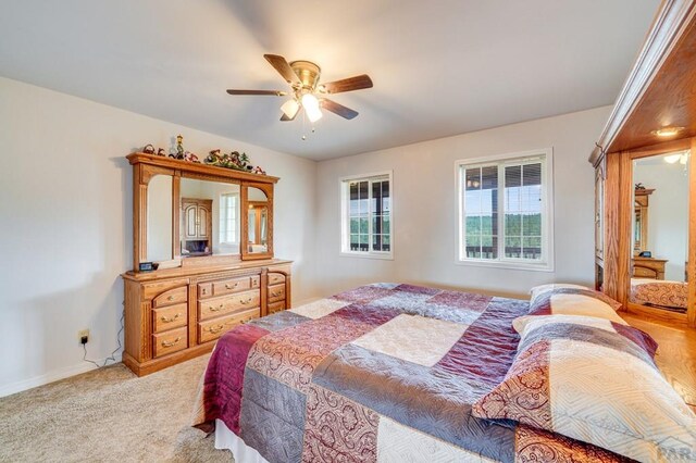 bedroom with light colored carpet and ceiling fan