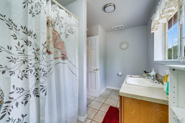 bathroom featuring curtained shower, tile patterned flooring, vanity, and baseboards