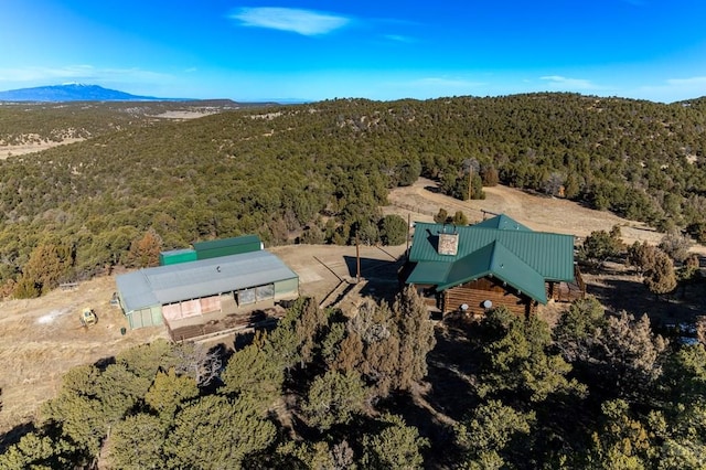 aerial view with a wooded view and a mountain view
