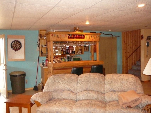 living room featuring stairway and a dry bar